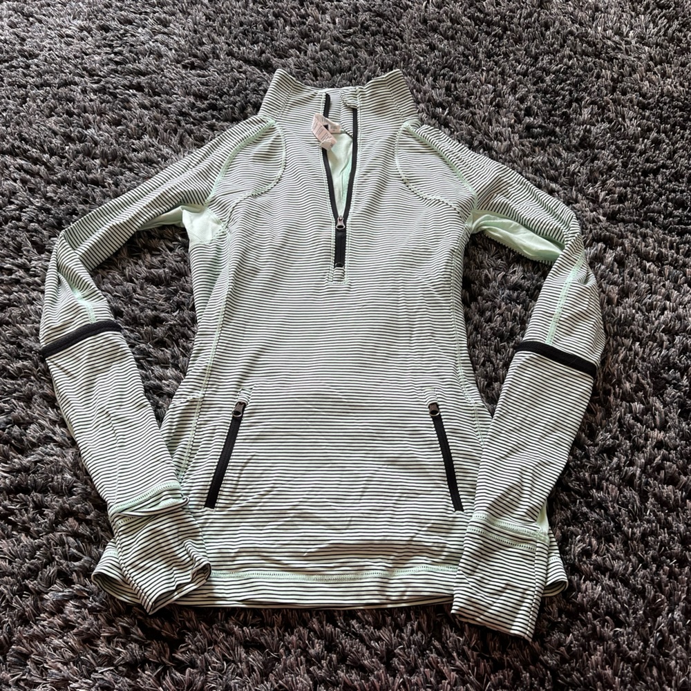 Beautiful mint green Lululemon zip up with black horizontal stripes.